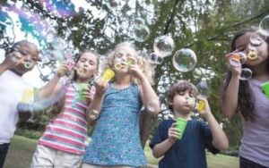 photo of children blowing bubbles